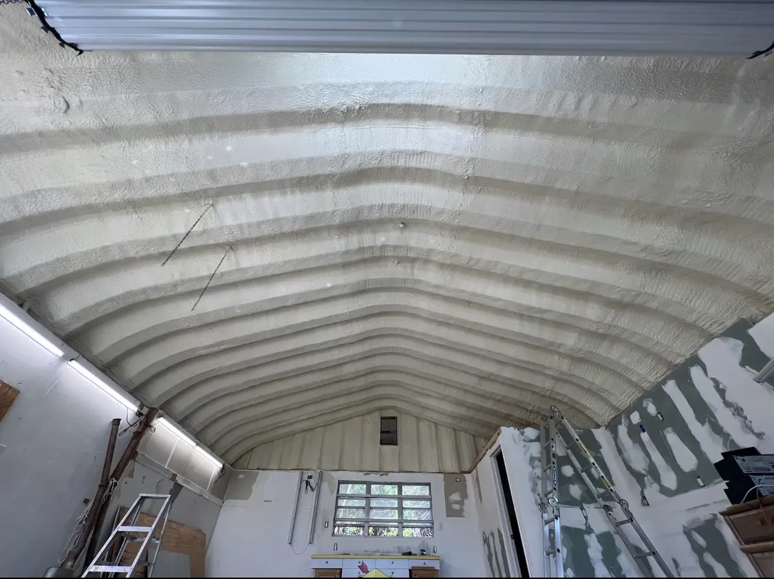 Spray polyurethane foam applied to the underside of a metal roof deck in Newberg